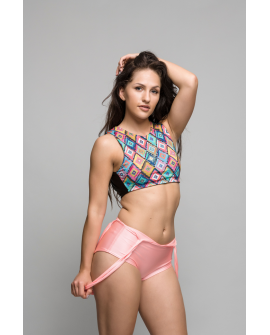 Suspenders pole dance shorts in peachy with elastic straps worn in multiple ways, front view
