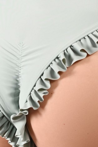 Detail of decorative flounces on lily water lily inspired dance shorts in sage green