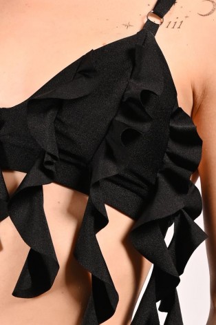 Detail of cascading flounces on lily water lily inspired dance top in black