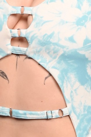 Close-up detail of Poetry Bodysuit showcasing blue rose print, decorative straps and elegant cut-out design