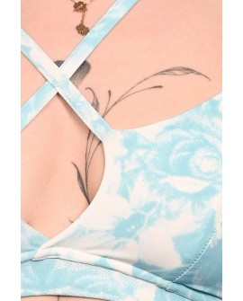 Close-up of Affair Top showing decorative adjustable straps and blue rose print detail