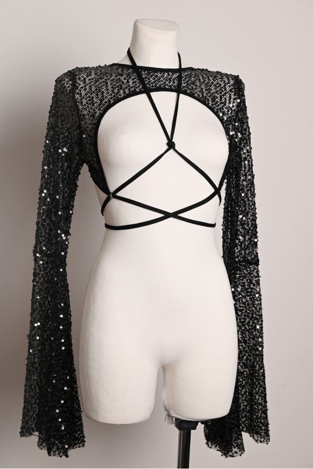 Witch Top in black, sheer sequin fabric with flared sleeves and adjustable styling straps, front view