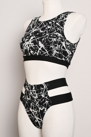 Splash Set black and white pole dance top and high-cut shorts with decorative hip straps, angled side view