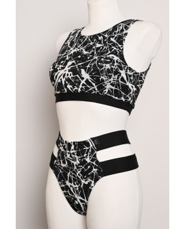 Splash Set black and white pole dance top and high-cut shorts with decorative hip straps, angled side view