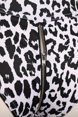 Close-up of the silver metal zipper detail on the back of the Leopard Zip Set animal print shorts