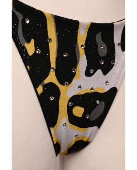 Close-up of Banana Bikini bottoms with yellow black and white print and sparkling rhinestones