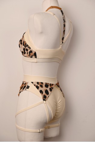 Close-up of the Vanilla Leopard pole dance bottoms with decorative straps and leopard-print inserts by Caro Line