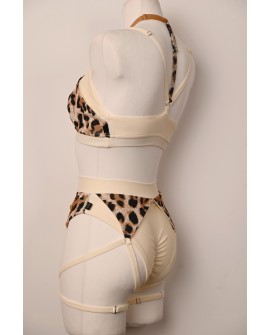 Close-up of the Vanilla Leopard pole dance bottoms with decorative straps and leopard-print inserts by Caro Line